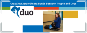Duo CEO Dawn Van Houten posing with an Assistance Dog in Training